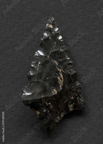 Obsidian arrowhead on white background