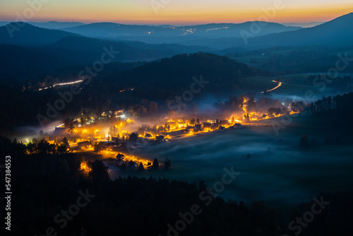 Evening landscape with fog in the valley in the National Park České Švýcarsko just after sunset from the rock Maria's viewpoint