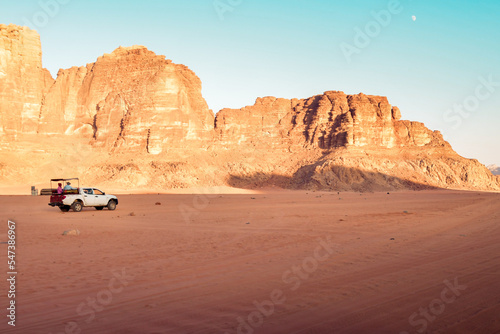 Offroad truck or suv riding dune in famous wadi rum desert at sunset. Offroad in Jordan Wadi Rum