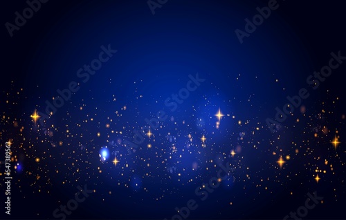 Golden glitter dust sparkles on blue background.