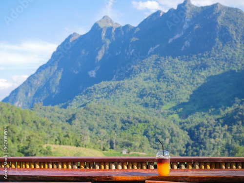 Coffee orange juice drink with mountain scenery