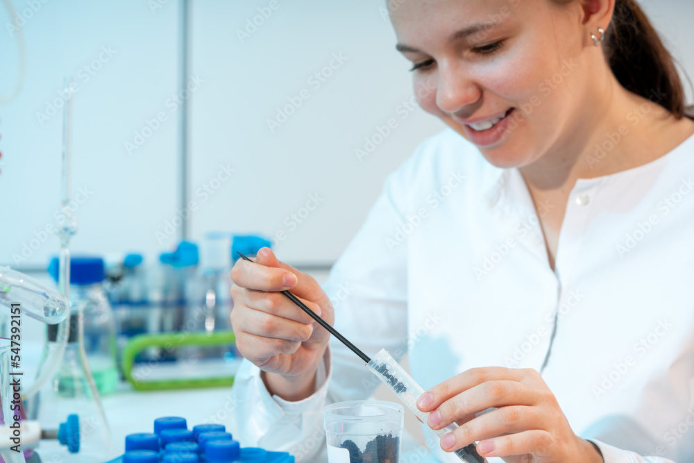 soil analysis for harmful chemicals in an agronomy laboratory young woman takes soil prose from a test tube for chemical analysis soil analysis for harmful chemicals in an agronomy laboratory young woman takes soil prose from a test tube for chemical analysis