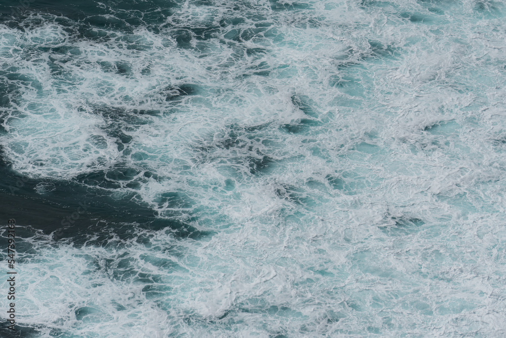The waves of the ocean water meet with underwater pointed rocks The waves of the ocean water meet with underwater pointed rocks