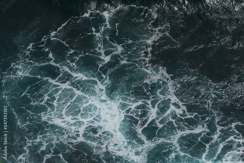 The waves of the ocean water meet with underwater pointed rocks The waves of the ocean water meet with underwater pointed rocks