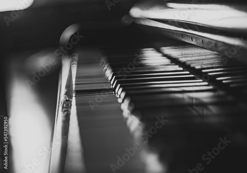 Black and white photo of old piano keyboard with the focus on a small part of the keyboard