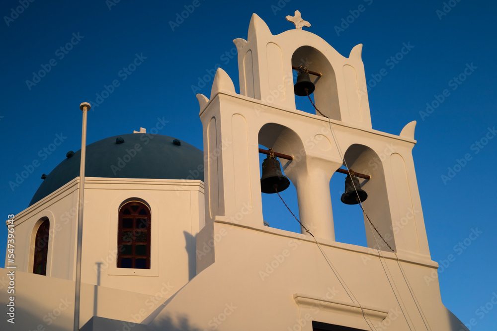 Sunset view of a bell tower of the church, Santorini, Greece