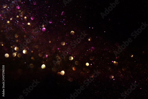 Tableau sur toile background of abstract glitter lights. gold and black. de focused