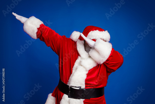 Photo of funky positive carefree old man dance make dab move wear santa hat costume isolated red color background