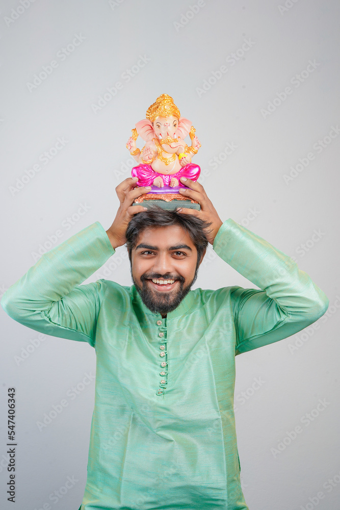 Young Indian man with Lord Ganesha , Celebrating Ganesha festival Young Indian man with Lord Ganesha , Celebrating Ganesha festival