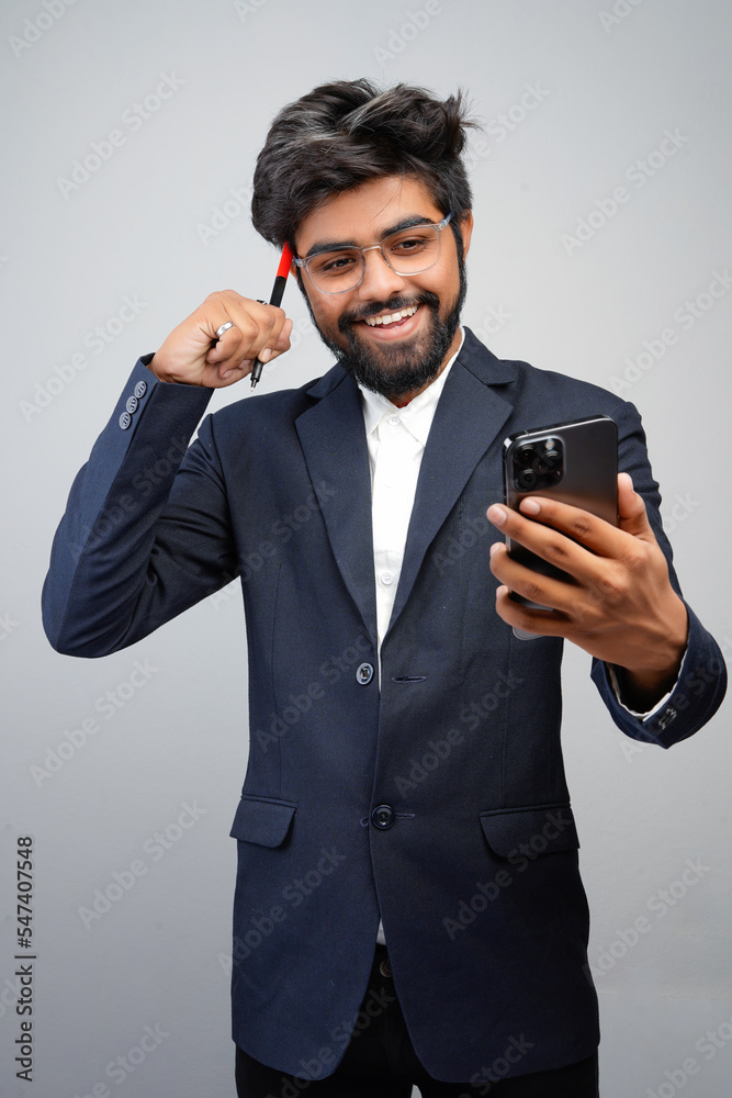 Businessman hand holding mobile phone and marker standing isolated on white background, Man in suit writing, using phone, thinking, video call conversation Businessman hand holding mobile phone and marker standing isolated on white background, Man in suit writing, using phone, thinking, video call conversation