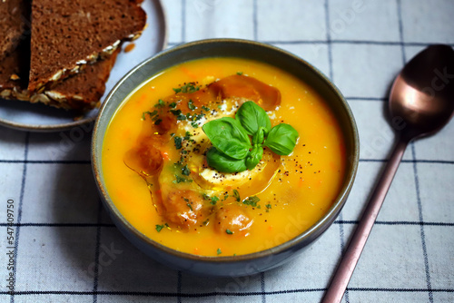 Pumpkin carrot soup with meatballs in a bowl. Autumn menu.