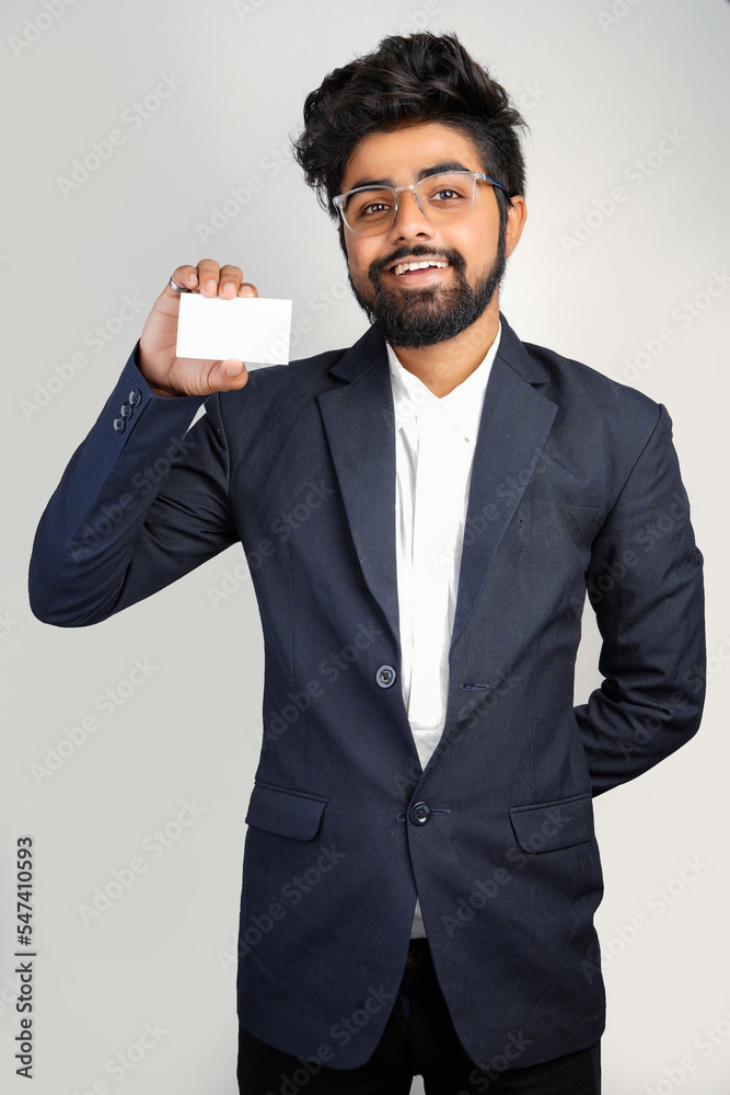 young indian Business man handing a blank business card Isolated on white. young indian Business man handing a blank business card Isolated on white.