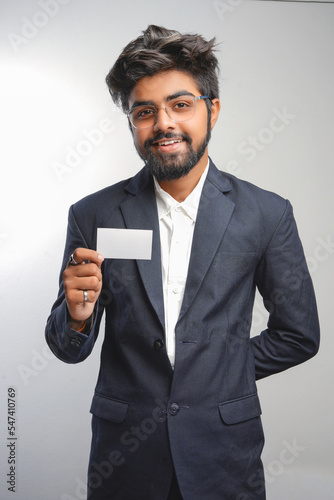young indian Business man handing a blank business card Isolated on white.