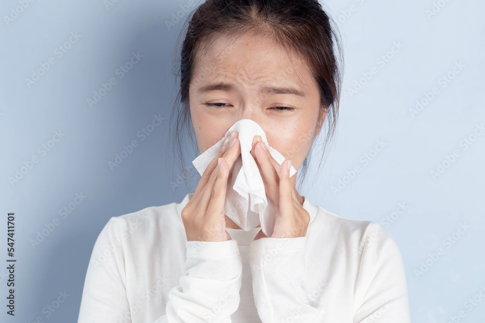 Sick Asian woman feeling unhealthy, seasonal health problems, chronic allergic rhinitis, colds, first symptoms of flu, virus, a respiratory infection. Sick Asian woman feeling unhealthy, seasonal health problems, chronic allergic rhinitis, colds, first symptoms of flu, virus, a respiratory infection.