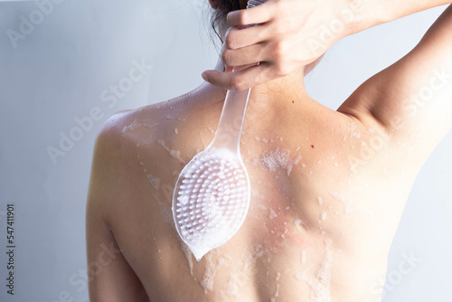 Wallpaper Mural Asian woman brushing her back, shower scrubbing back view, cleaning back skin Torontodigital.ca