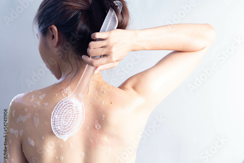 Wallpaper Mural Asian woman brushing her back, shower scrubbing back view, cleaning back skin Torontodigital.ca