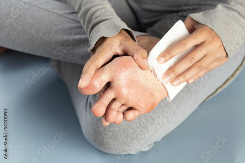 Hyperhidrosis, woman suffers from hyperhidrosis on feet, health care concept photo