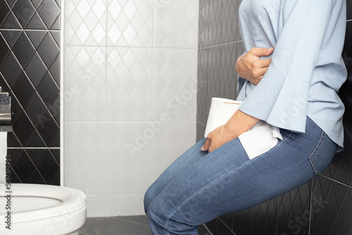 Wallpaper Mural woman feeling severe pain in the lower abdomen, exhausted woman leaning against the toilet wall, urinary tract infection, cystitis, dysmenorrhea, gonorrhea, gynecology Torontodigital.ca