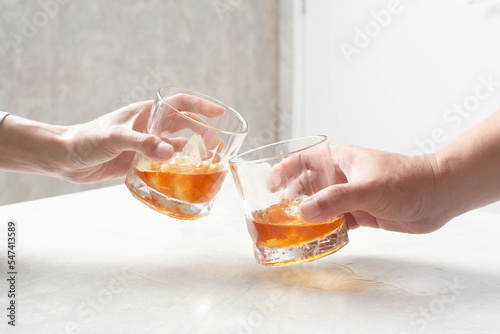Man and woman clinking whiskey drinking alcohol together at home, young people friendship concept