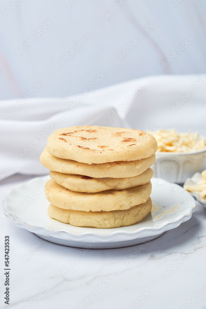 Arepa made from ground corn dough, cornmeal, traditional in the cuisine of Colombia and Venezuela with copy space Arepa made from ground corn dough, cornmeal, traditional in the cuisine of Colombia and Venezuela with copy space