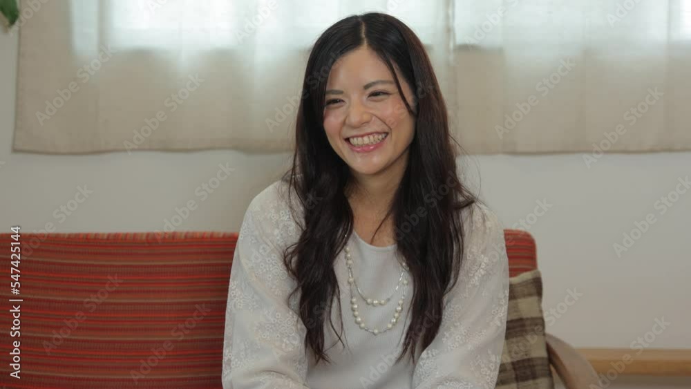 Asian young wife having a conversation with her friend at living room. Fun, Happy, Cheerful. Asian young wife having a conversation with her friend at living room. Fun, Happy, Cheerful.