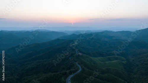 twilight landscape aerial view of long curve road No.1081 also known as over sky road, is a long road behind the mountain, beautiful in the last rainy season and early winter of nan province, Thailand