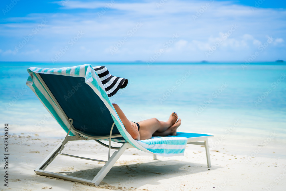Young Woman In Bikini Sunbathing On Deck Chair Young Woman In Bikini Sunbathing On Deck Chair