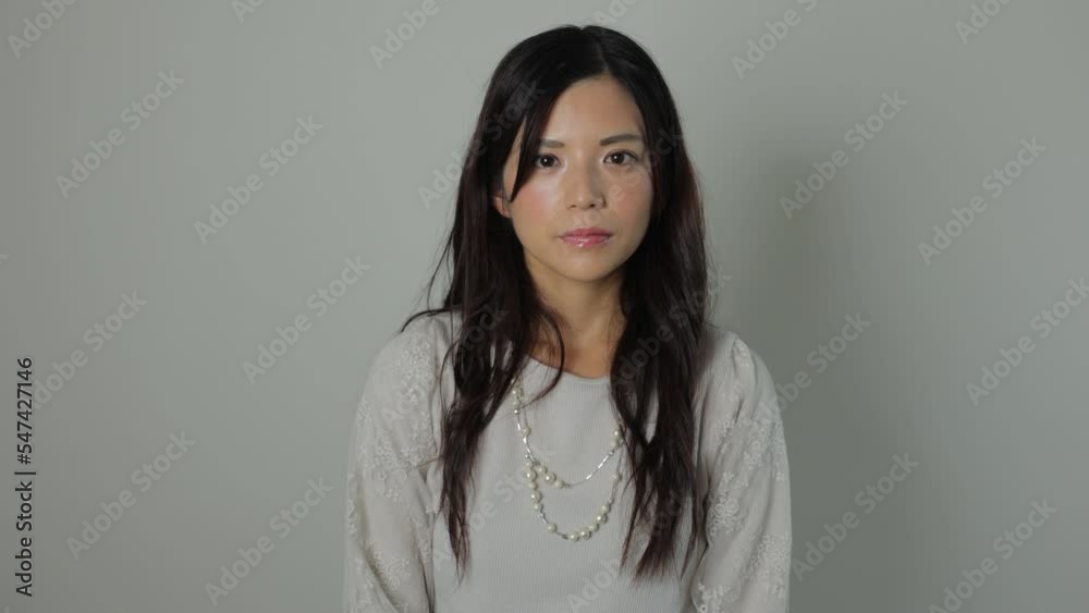 Beautiful Japanese woman opens her eyes and stares the camera. Emotionless, Still, Protest. Dolly out. Beautiful Japanese woman opens her eyes and stares the camera. Emotionless, Still, Protest. Dolly out.