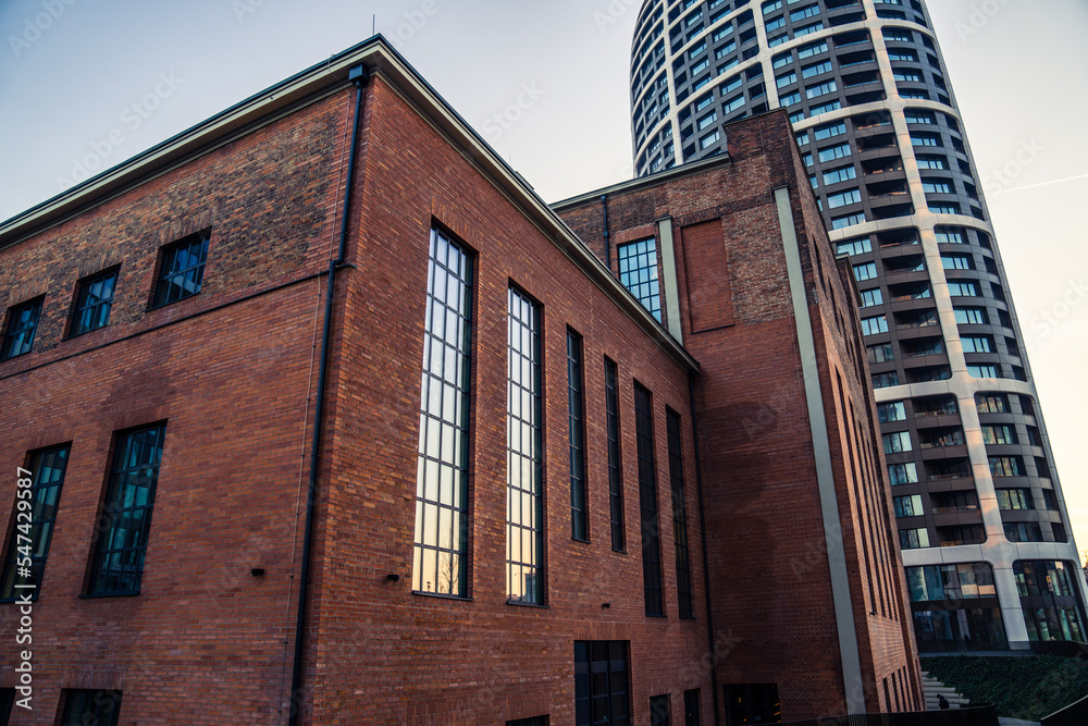 Red brick building with skyscraper in background