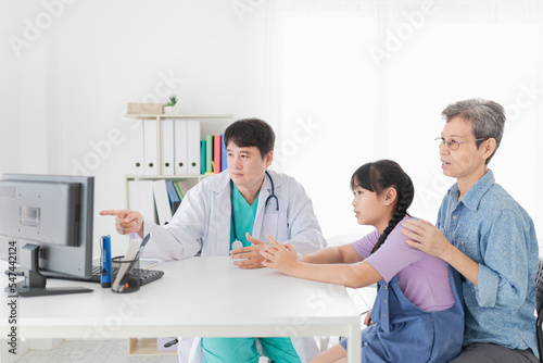 asian doctor diagnosis and explaning to child patient about disease symptoms, treatment process in hospotal