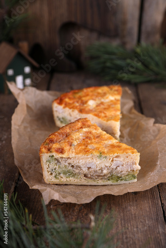 Quiche with chicken and broccoli on a wooden table
