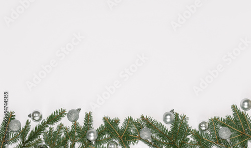 Top view Christmas new year flat lay on white background. Fir branches with christmas balls and decorations. 