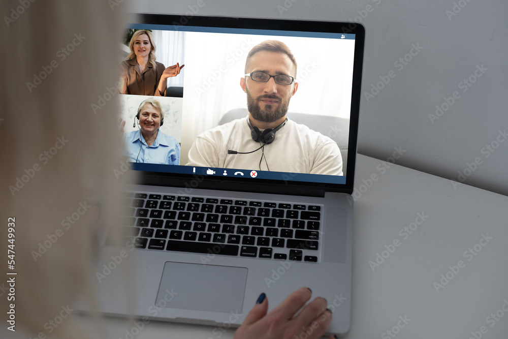 Back view of woman making video call with her doctor while staying at home. Close up of patient in video conferencing with general practitioner on digital tablet. Sick girl in online consultation