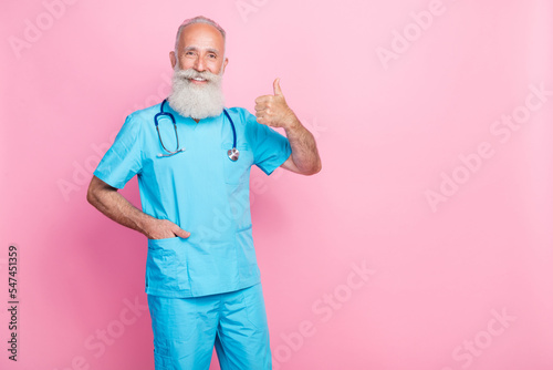Photo of qualified retied pediatrician make thumb up symbol advertise medical offer isolated on pastel color background photo