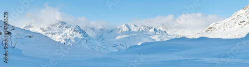 Panoramic view of the winter high mountains in Switzerland Alps.