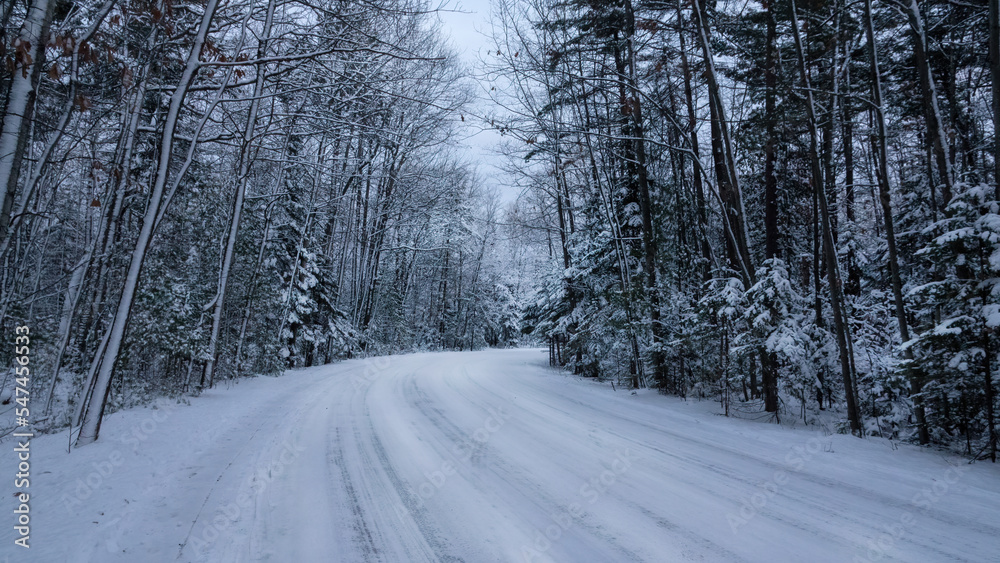 Empty road with snow banks on sides Empty road with snow banks on sides