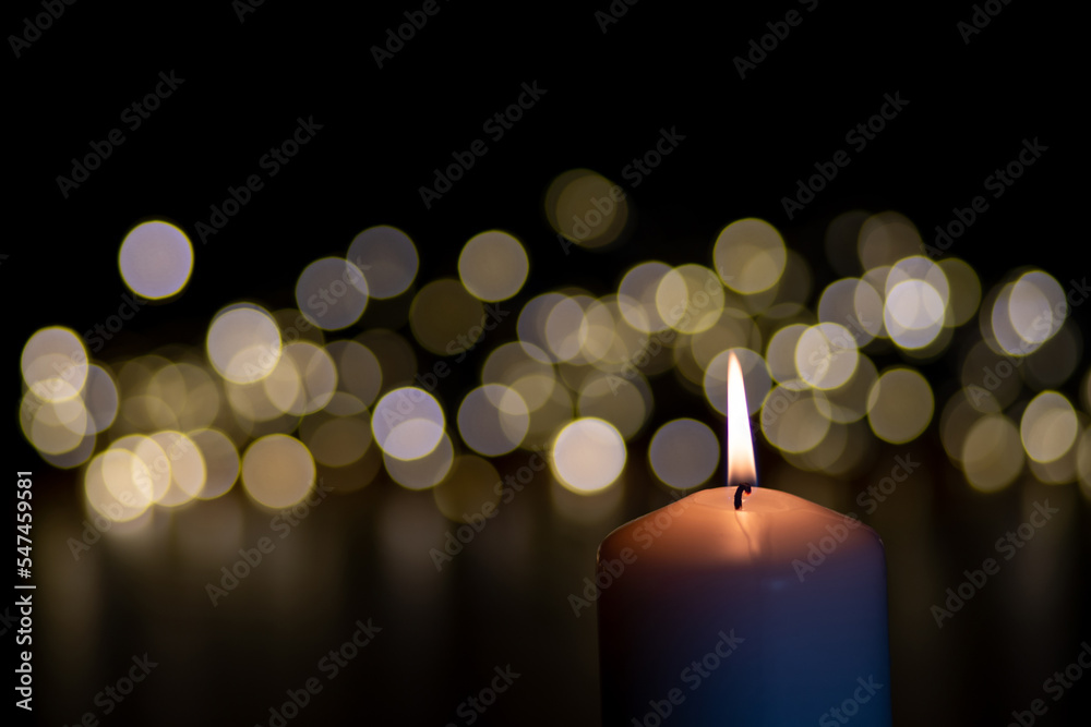 candles in the dark with Christmas lights in the background, copy space candles in the dark with Christmas lights in the background, copy space