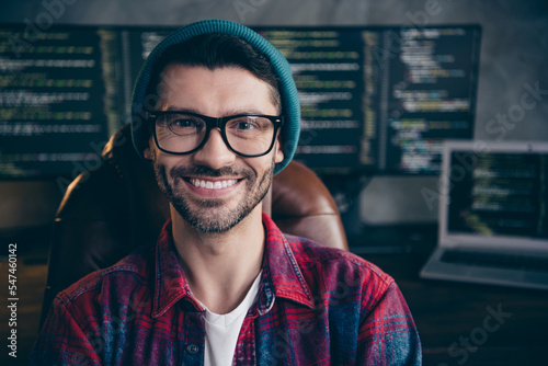 Photo of positive cheerful guy dressed eyewear smiling creating new start up indoors workstation workshop home