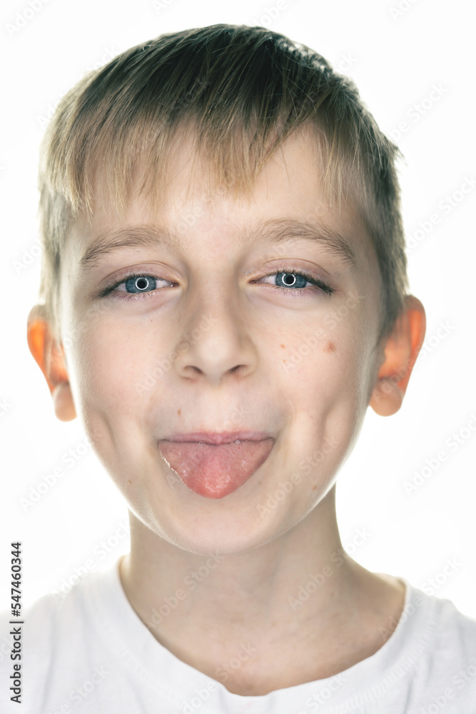 portrait of a smiling boy, tongue out, white background portrait of a smiling boy, tongue out, white background