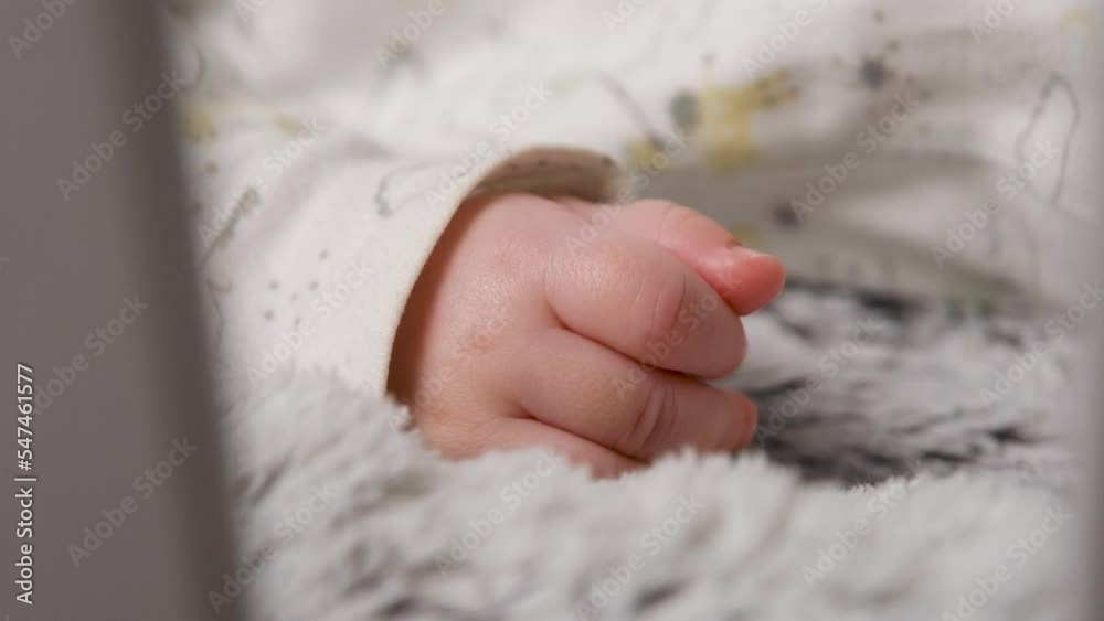 Close up of little baby hand and tiny fingers. Newborn child playing