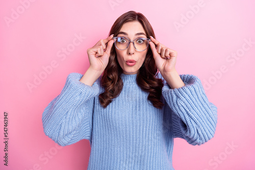 Closeup photo of young childish girl wavy brunette hair wear warm autumn knitted sweater after checkup vision isolated on pink color background