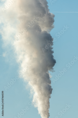 Column of smoke coming out of an industrial chimney.