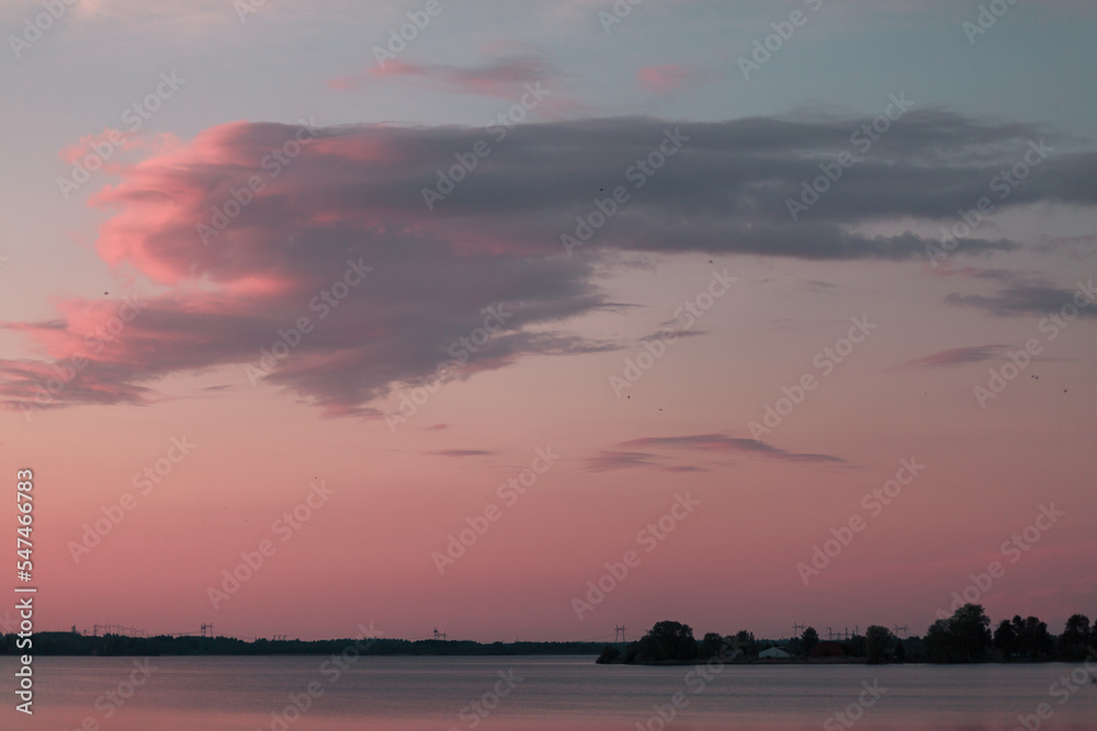 Pink sunset on the lake in summer.