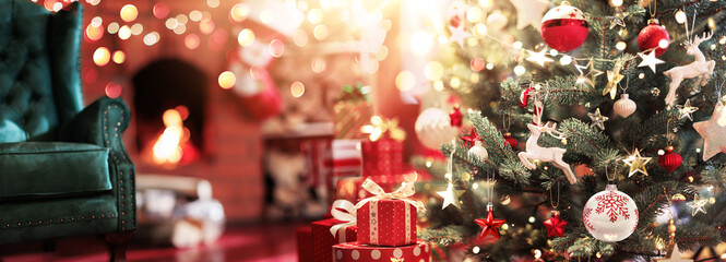 Christmas tree with toys and gifts on the background of a fireplace with fire. Magical room with the throne of Santa Claus