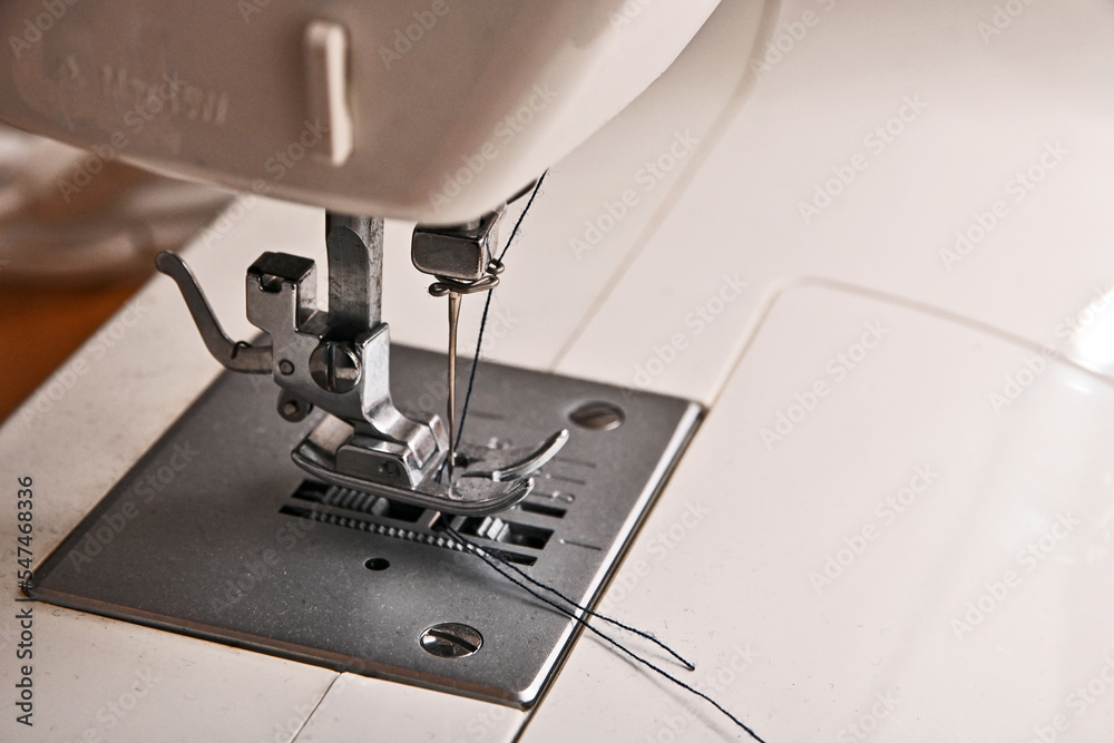heated thread into the sewing machine needle