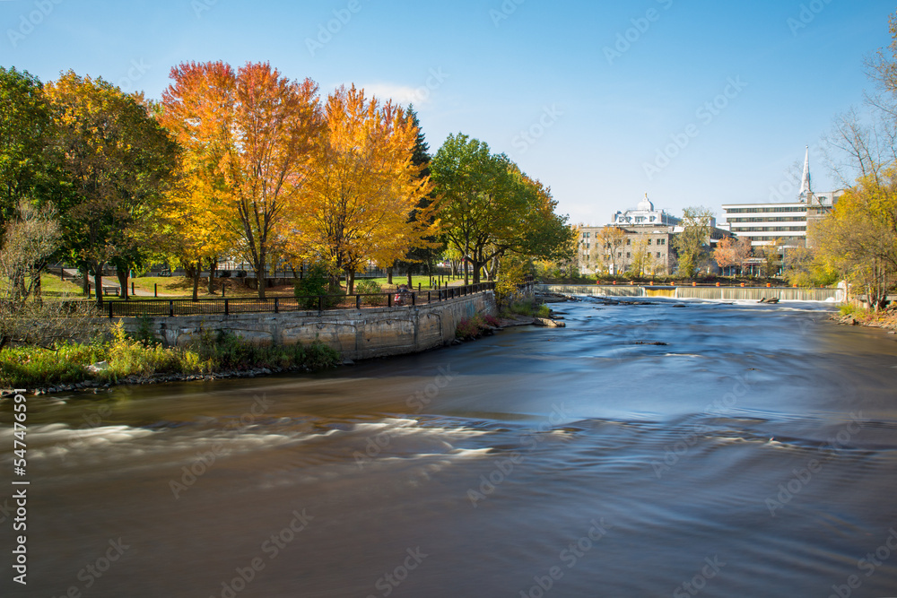 Fototapeta premium Slow motion streaming water. Waterfalls in L'Assomption river, Joliette, Quebec, Canada