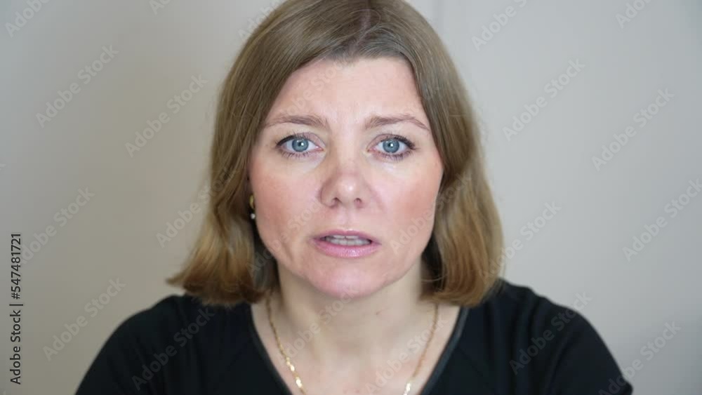 Close up view of woman conducting presentation in live broadcast and looking directly intocamera. Confident woman communicates in official suit uses video call application. Coach online school webinar Close up view of woman conducting presentation in live broadcast and looking directly intocamera. Confident woman communicates in official suit uses video call application. Coach online school webinar