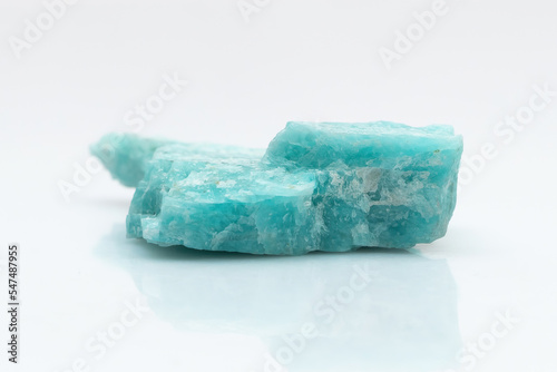 Natural amazonite gemstone isolated on white background. A bluish-green crystal on a white background. A variety of potassium feldspar microcline photo