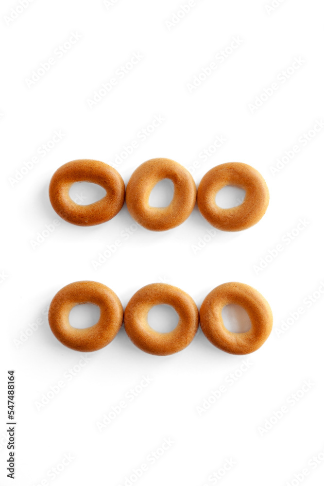 Symbol = bagel. Bagels font. Alphabet from set of small dry bagels isolated on white background. ABC symbols. Symbol = bagel. Bagels font. Alphabet from set of small dry bagels isolated on white background. ABC symbols.