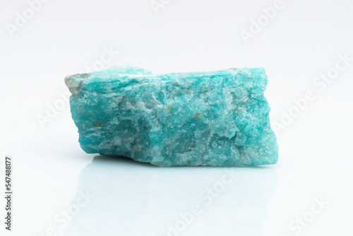 Natural amazonite gemstone isolated on white background. A bluish-green crystal on a white background. A variety of potassium feldspar microcline photo